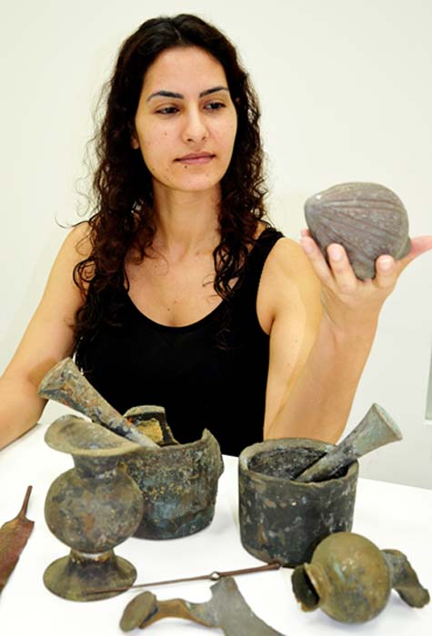An Israel Antiquities Authority employee examining the finds.