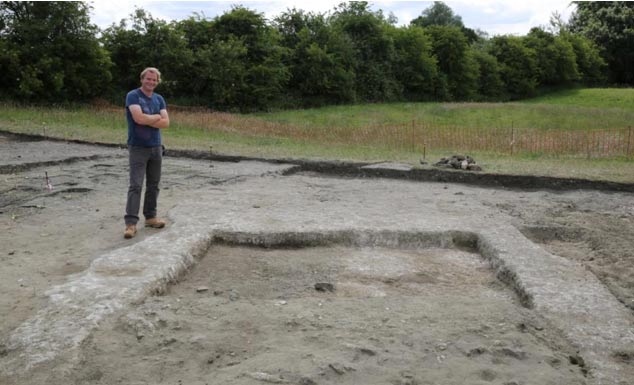 Jim Leary, lead archaeologist, with the remnants of the walls and the floor of the ancient home at Marden Henge. (University of Reading)