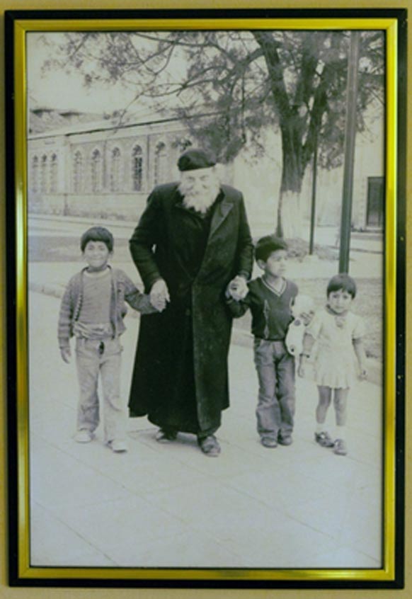 Photograph of Father Crespi with some local children. Crespi Museum in the Universidad Politécnica Salesiana.