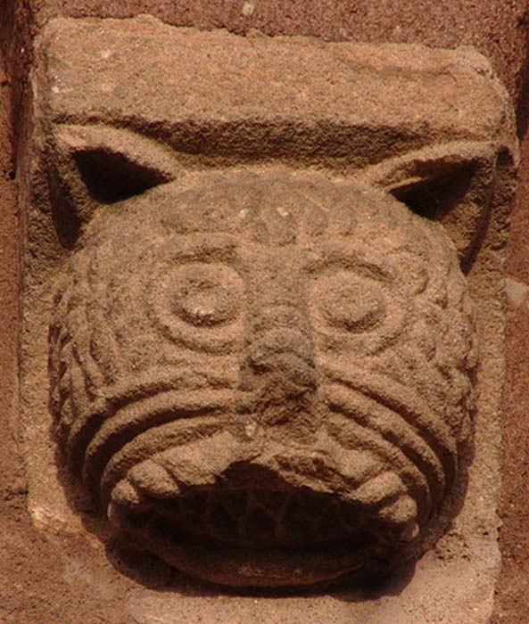 Romanesque relief head of cat at Sigolshein, France. 