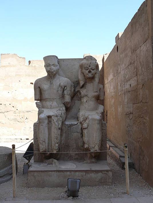 Statues of a young Tutankhamun and his consort Ankesenamun outside at Luxor Temple, Luxor, Egypt.