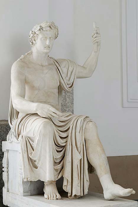 A colossal statue of a seated Augustus (Octavian) with a laurel crown