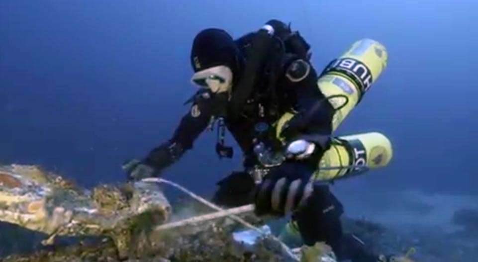 A diver securing an artifact found on the sea floor