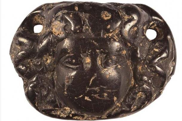 An ornate Roman jet pendant depicting the head of Medusa was found by archaeologists.