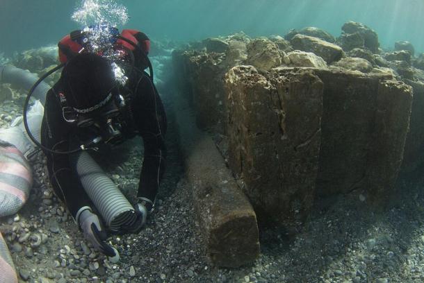 Archaeologist documenting wooden caisson