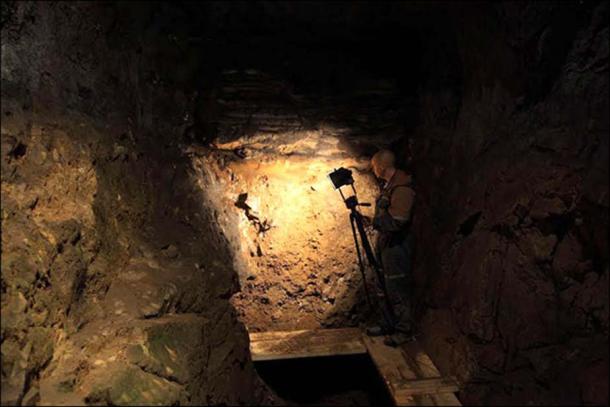 Archeologists working inside the eastern gallery of the Denisova Cave.