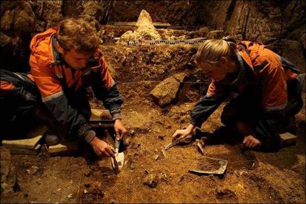 Archeologists working inside the eastern gallery of the Denisova Cave.