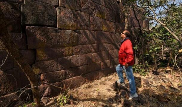 Examining the immense wall.