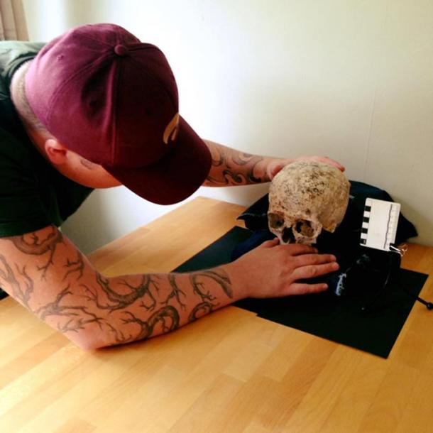 Hew Morrison studying the skull of ‘Ava’. 