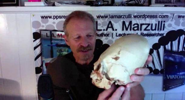 LA Marzulli holding up a replica of one of the Paracas skulls that was tested