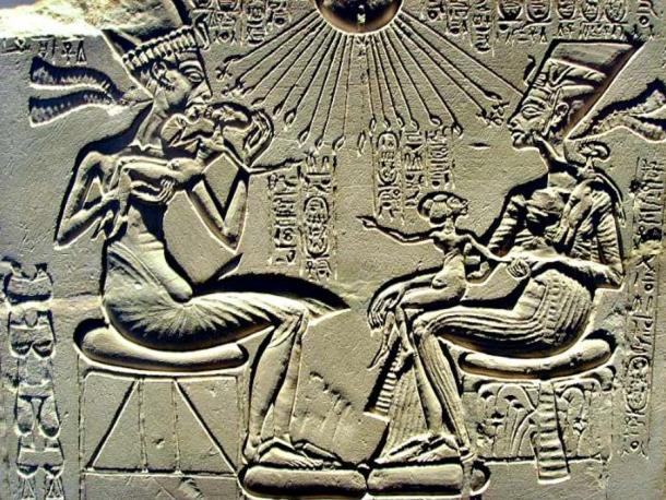 Limestone relief that was probably part of a family worship altar. Akhenaten holding up his firstborn Meritaten and, in front of both, Nefertiti holds Meketaton, her second daughter (who died prematurely), in her lap. On her left shoulder is Anjesenpaaton her third daughter, who later would marry Tutankhamen. Berlin Museum.