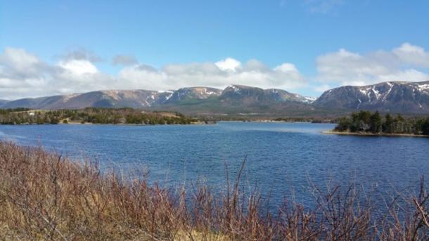 The Little Codroy River, with the Long Range mountains in the background and the potential site of a Norse settlement visible in the middle-ground, to the left.