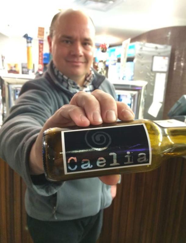 Colorado State University Professor Jonathan Carlyon with a bottle of caelia from a Spanish microbrewery