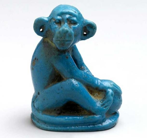 This blue glazed faience monkey                  seated on an ovoid base holds a round object, perhaps a                  ball or a piece of fruit, in its forepaws. In antiquity                  the animal's pierced ears had metal earrings indicating                  that it was a household pet. 18th Dynasty. Tell el                  Amarna. Brooklyn Museum, New York.