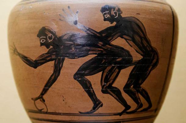 Two youths engaged in sex, one of them holding a hoop. Detail from an amphora 