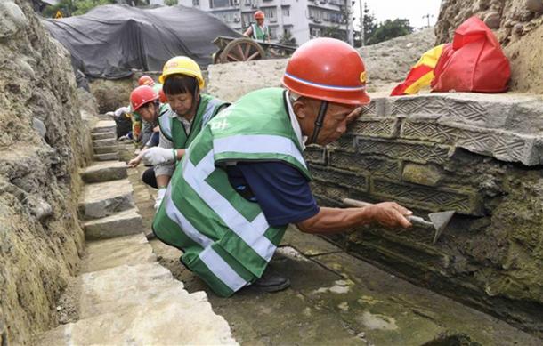 Workers inside an unearthed ditch at the excavation site of the Fugan Temple, Chengdu, China.
