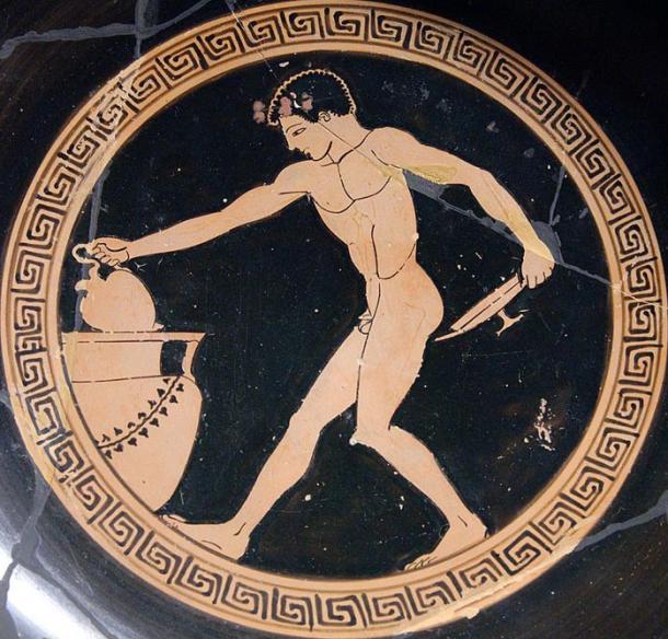 Jóvenes usando un oinochoe (jarra de vino, en la mano derecha) para dibujar vino de un cráter, con el fin de llenar un kylix (copa poco profunda, en la mano izquierda).  Su desnudez muestra que está sirviendo como un escanciador en un simposio o banquete.