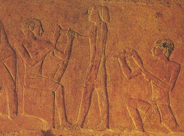 Ancient Egyptian sculptors making a statue.
