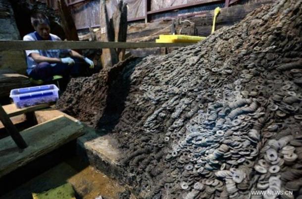 Archaeologists found 10 tons of bronze coins in and around the tomb of a dethroned Chinese emperor of the first century BC.