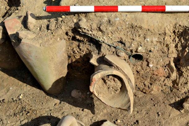 The recently discovered simpulum (ladle used for extracting wine) can be seen partially uncovered at the top of this photo.