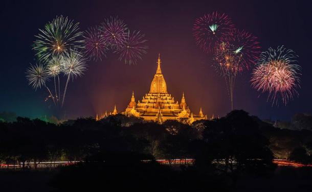 Fireworks over a golden temple.
