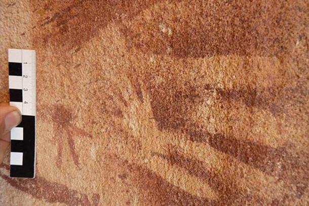 A tiny hand, originally assumed to be of a very young child or infant was stenciled inside the outline of an adult hand on the wall of the Wadi Sura II rock shelter about 8,000 years ago. New research suggests that the prints were actually made by reptiles.