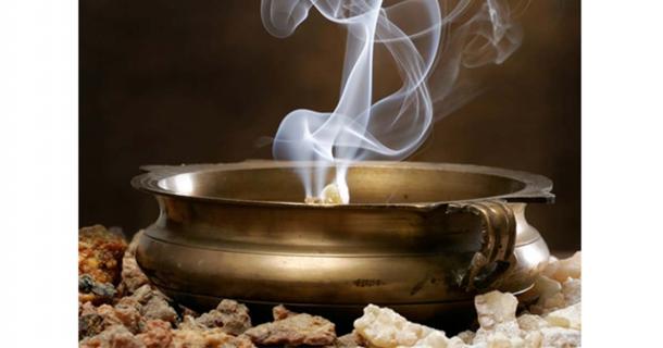 A copper bowl burning frankincense.