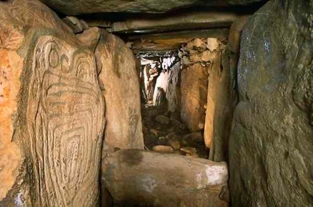 Western passage at the megalithic site of Knowth with decorated orthostat on left. Co. Meath, Ireland.