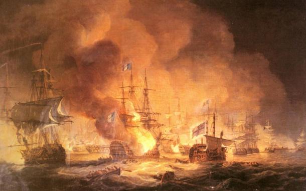A confused naval battle. Two battered ships drift in the foreground while smoke and flame.