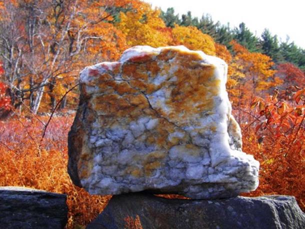A large quartz block sits atop a stone lining