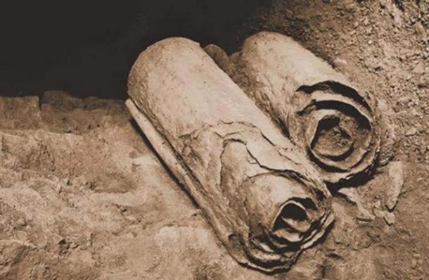 Two scrolls from the Dead Sea Scrolls lie at their location in the Qumran Caves before being removed for scholarly examination by archaeologists.