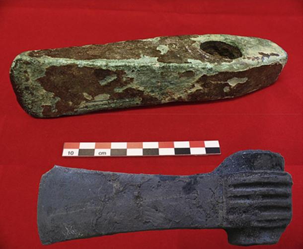 Photo of two massive shaft-hole axes that match Cypriote ores - a shaft-hole axe of Valsømagle type, dated to 1600-1500 BC and a shaft-hole axe of Fårdup type, dated to 1600-1500 BC. The former axe was discovered in a bog together with horse bones and a stone paving with post holes.