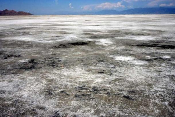 The size of the shallow lake fluctuates due to evaporation. Salt on the dried ground at Great Salt Lake. 