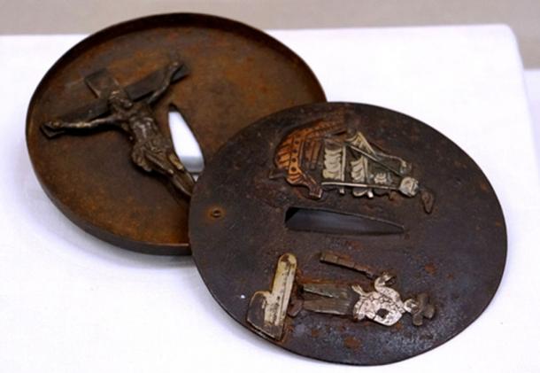 A sword guard identified as belonging to a hidden Christian has a statue of Jesus Christ inside it, while a foreign vessel is engraved on its outer side.