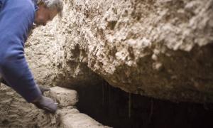 Professor Stuart Tyson Smith opens an intact tomb with the coffined, mummified burial of an elderly woman inside. 