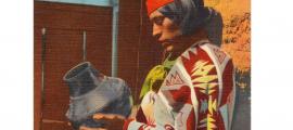 This postcard shows a Pueblo Indian man with San Ildefonso Black Pottery. The postcard was published between 1930 and 1945. 