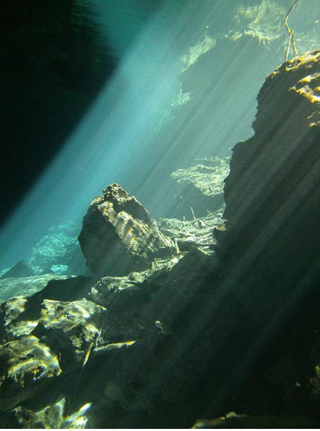 Beautiful cenotes, water-filled caverns beneath the ground in Mexico, are thought to have been sacred to the ancient Maya. Light underwater on the rocks Kukulkan Chac Mool Mexico.