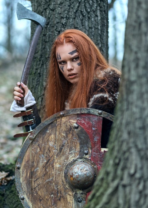 Celtic woman warrior woman ready to attack. (danrentea / Adobe)
