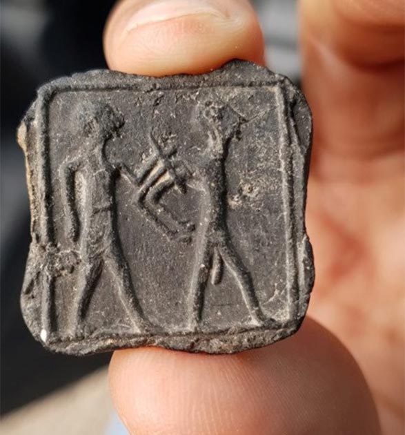 Clay plate late of captive and captive. (Israel Antiquities Authority)