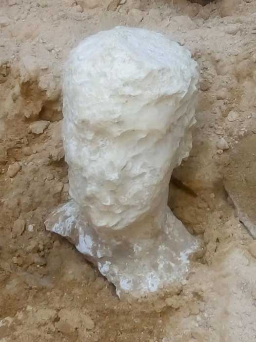 Deteriorated alabaster bust of a man was found with the coffin. (Ministry of Antiquities)
