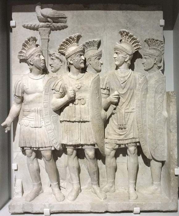 The Emperor’s Protector was a title earned by less than ten elite bodyguards serving in the Praetorian Guard. This stone relief shows the Praetorians with an eagle grasping a thunderbolt with its claws. (JÄNNICK Jérémy / Wikimedia Commons & Louvre-Lens)