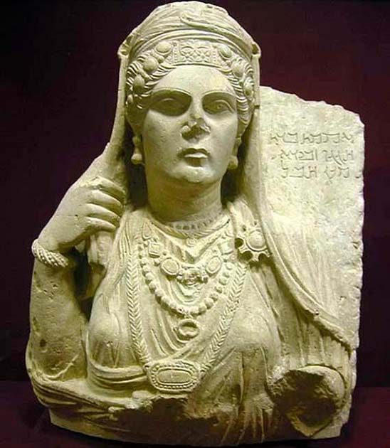 Funerary bust of Aqmat, daughter of Hagagu, descendant of Zebida, descendant of Ma'an, with Palmyrenian inscription. Stone, late 2nd century AD. From Palmyra, Syria. (CC BY SA 3.0)