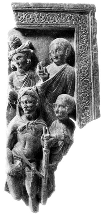 The Greek Buddhism influenced art of Gandhara typifies Buddhism’s Hellenistic connections. Herakles-Vajrapani amongst monks, schist relief, issued (circa 100-200 AD). Herakles-Vajrapani stands frontally in a relaxed “Praxitelean” (Greek style) posture. His head is slightly inclined, facing left, and covered with a lion skin with paws tied on his chest in a typical knot. (The Trustees of the British Museum)