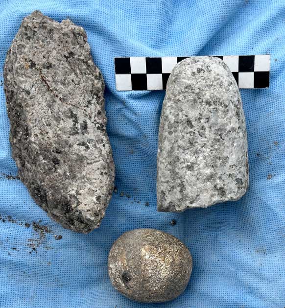 Grinding tools typical of ancestral Maya farmsteads found at the Belize settlement site included a metate fragment (left), a round stone (bottom) and a mano fragment (right). Metates and manos were used to grind maize. (©2022 VOPA and Belize Institute of Archaeology, NICH / University of Illinois)