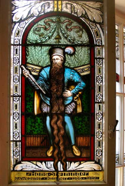 A stained glass window of Hans Staininger in the Church of St. Stephan in Braunau am Inn. Staininger’s strange death was caused by tripping over his own long beard (Gerd Eichmannn / CC BY SA 4.0)