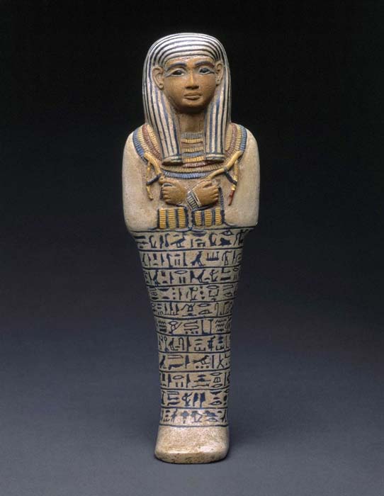 In the Egyptian view, this image of a woman, Lady Sati, has a male face and hands because they are colored red—the “male” color. This use of color magically transformed Sati into a male being which gave her access to transportation to the next life in the Sun god Ra’s boat. This shabti, made by a rare and expensive process using multiple colors of faience, was likely a product of a royal workshop. 18th Dynasty. Saqqara, Egypt. Brooklyn Museum. (Image: Brooklyn Museum)