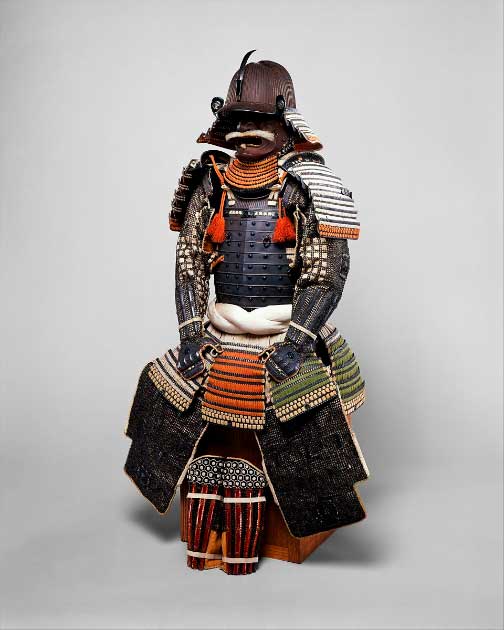 18th century Gusoku armor from Japan. The helmet bowl is made from 84 ridged iron plates and the cuirass consists of eight vertical plates connected with ornamental rivets  Iron, lacquer, copper-gold alloy, silver, silk, horse hair, and ivory. Source: The Metropolitan Museum of Art, Public Domain.