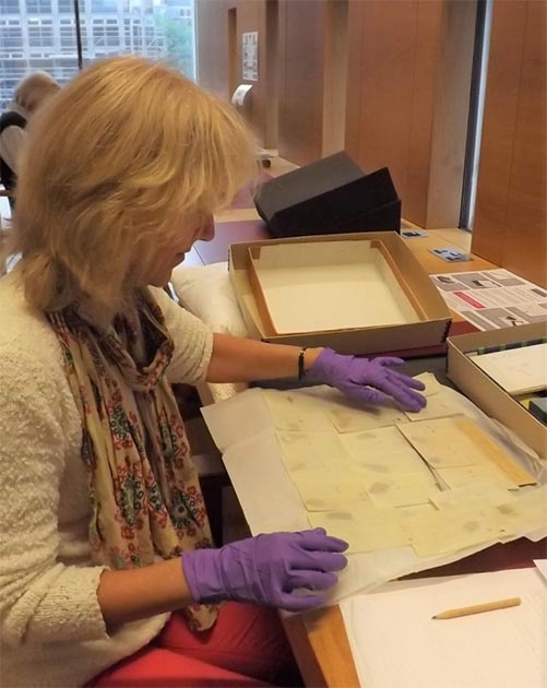 Joan Taylor examining the Dead Sea Scroll fragments in the John Rylands Library Reading Room. (University of Manchester)
