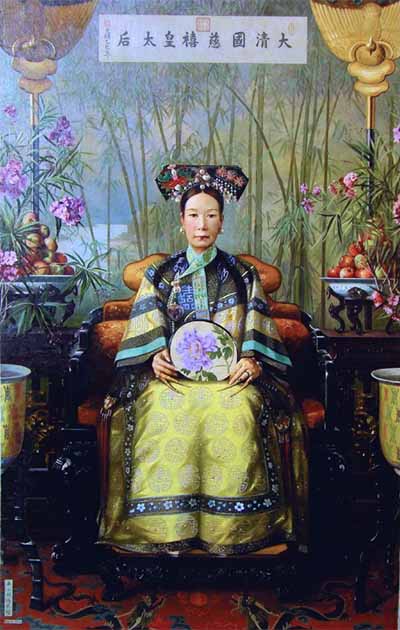 Oil painting of the dowager Empress Cixi of Qing Dynasty sitting on an armchair, by Dutch painter Hubert Vos, 1906. On the bamboo forest painted background, there is written from right to left, in traditional Chinese "Great Qing Empire Cixi Empress". Cups of fruits surround the empress, as for any highest rank personality in Imperial China. (Public Domain)