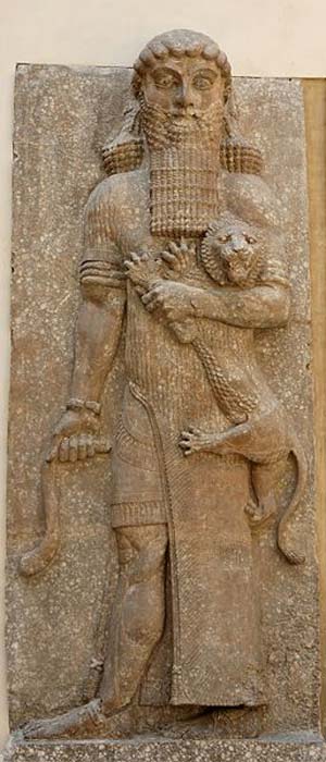 Possible representation of Gilgamesh as Master of Animals, grasping a lion in his left arm and snake in his right hand, in an Assyrian palace relief, from Dur-Sharrukin, now held in the Louvre. (Public Domain)